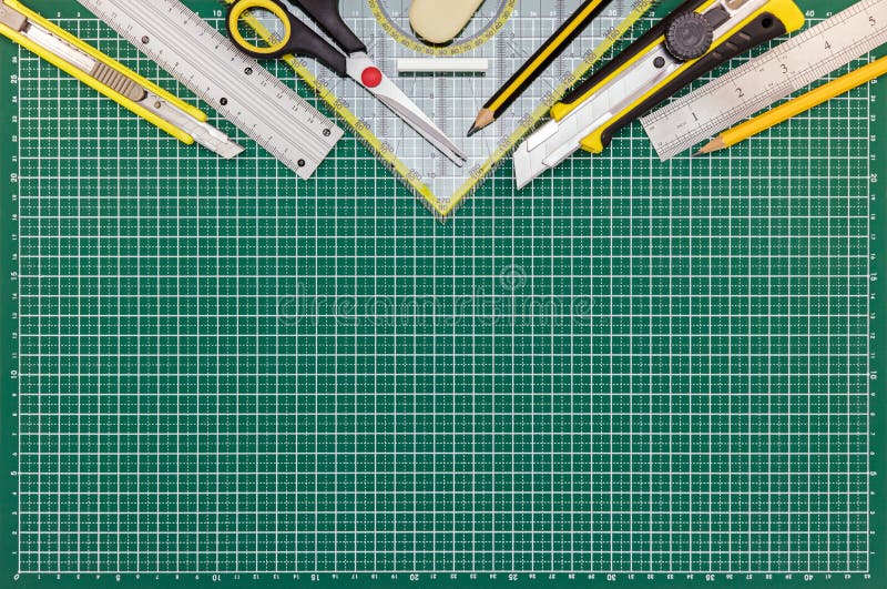 Green Cutting Mat on Desk with School or Office Supplies Stock Image