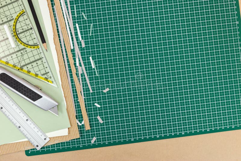 Green Cutting Mat with School Supplies and Office Tools on Desk Stock
