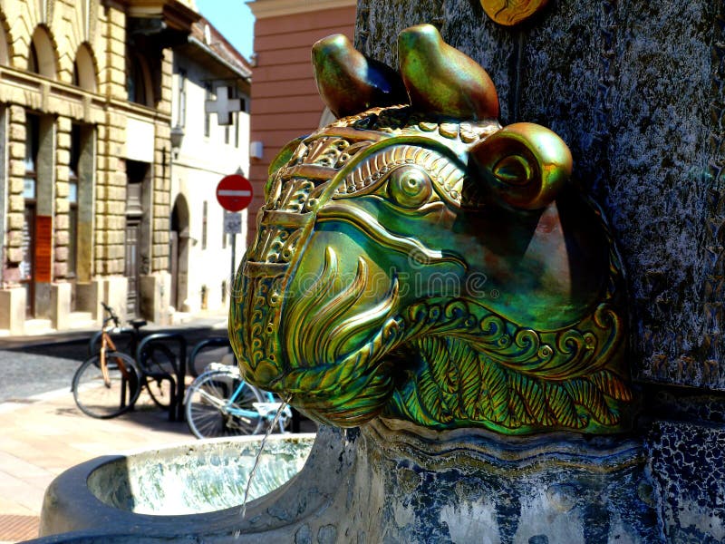 Green enamel coated ceramic fountain water scupper in the shape of an ox head in the town of Pecs, Hungary