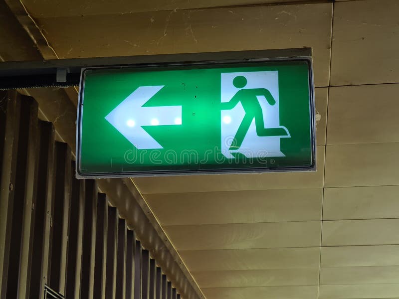 Green exit sign with a running person icon indicating the way out royalty free stock images