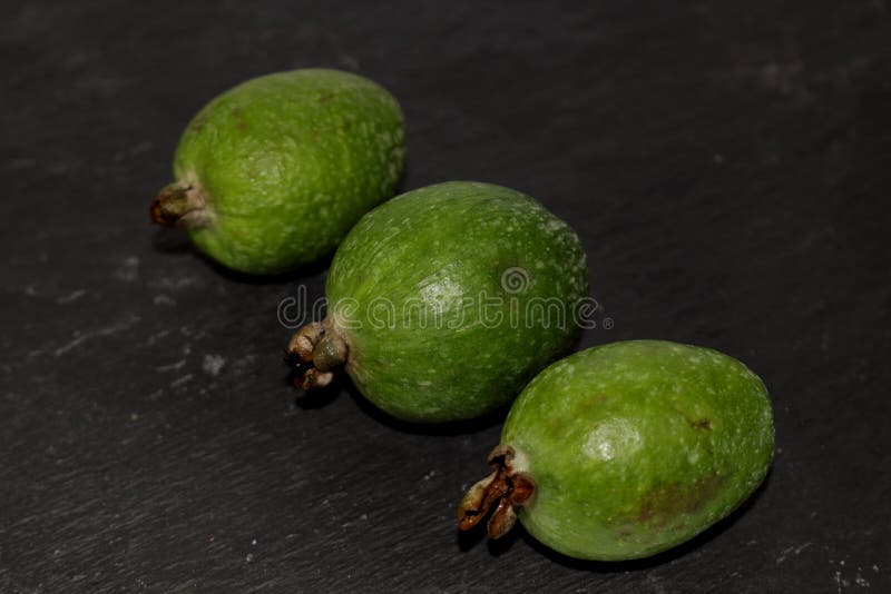 Green exotic fruits feijoa on a black background stock photography Green exotic fruits feijoa on a black background stock photography