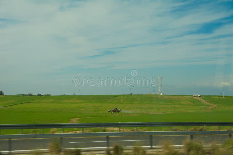 Green Feilds and Highway Mooving Cars Veiw from Side. the Road Along