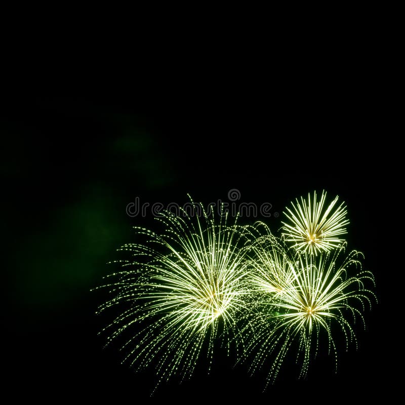 Green fireworks border on the black sky background with copyspace