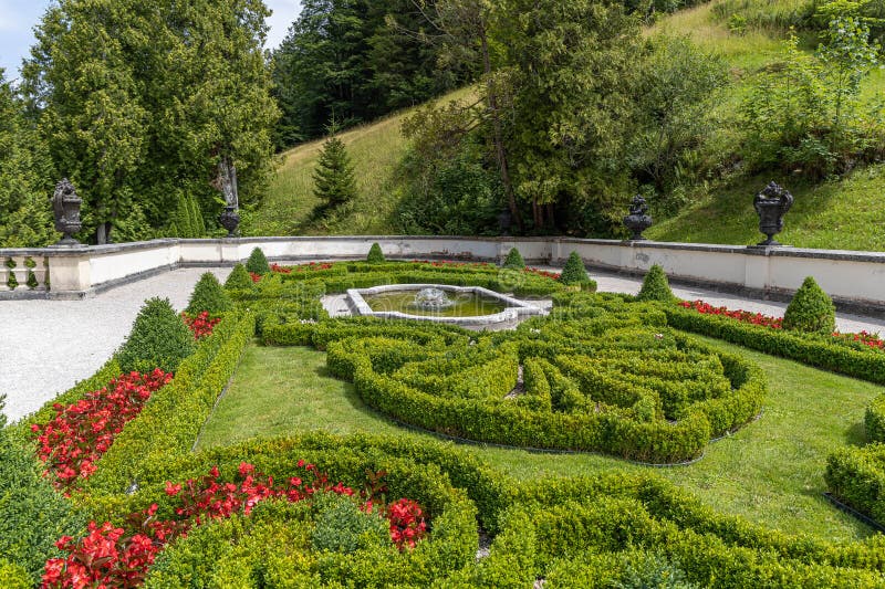A green flower bed with red accents created a pattern from flowers stock image