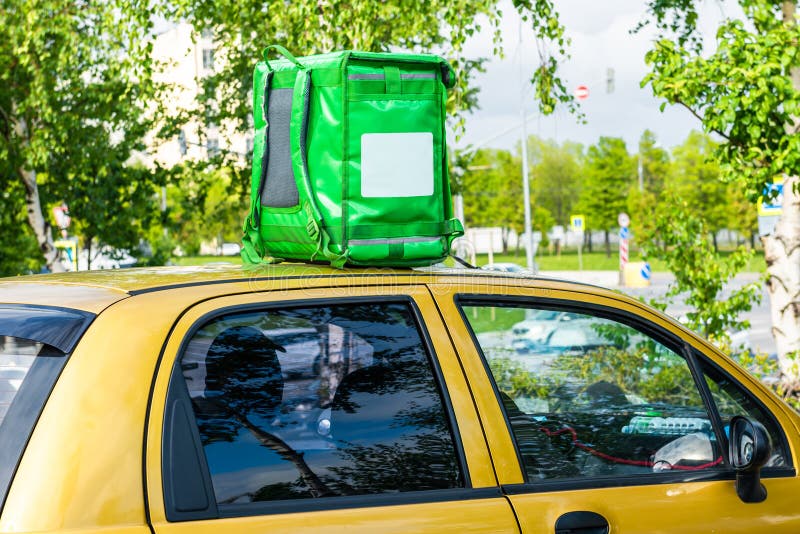 Download Green Food Delivery Backpack Standing On The Top Of Yellow Car. Mockup Box For Food Delivery ...