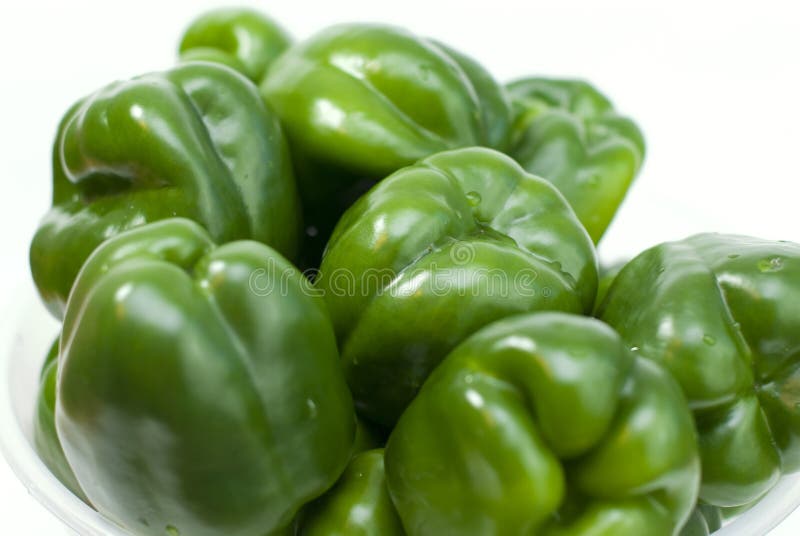 Green fresh peppers on white background