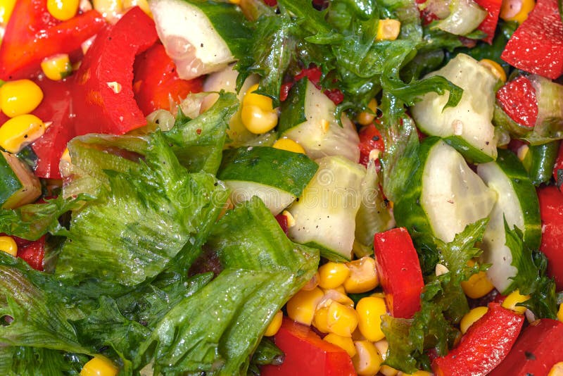 Green fresh salad. Salad with corn, red sweet pepper, cucumber and lettuce. Concept for healthy nutrition close up