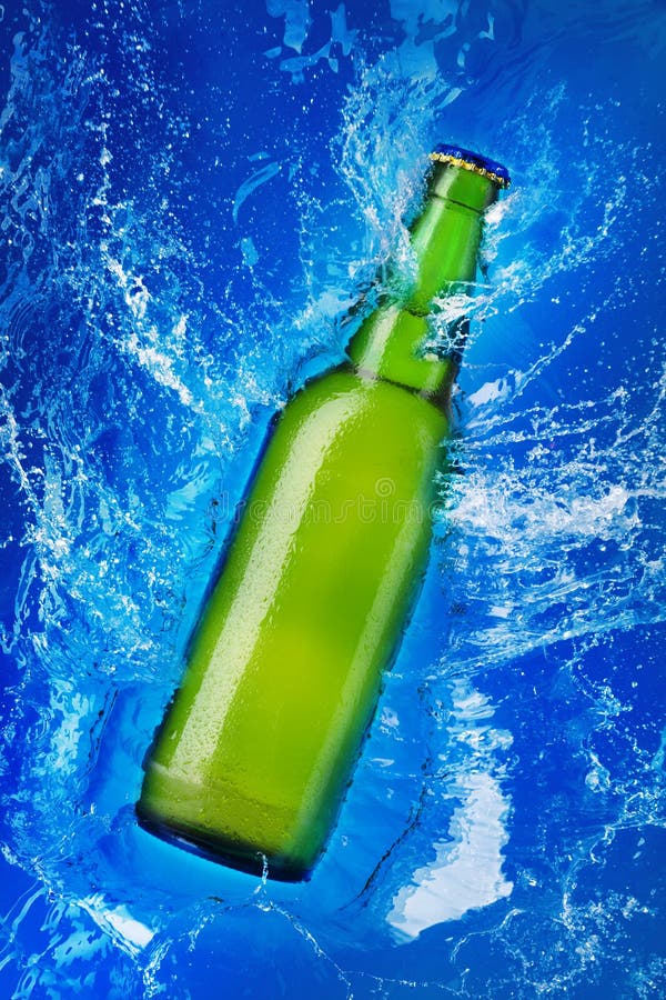Green glass bottle in water