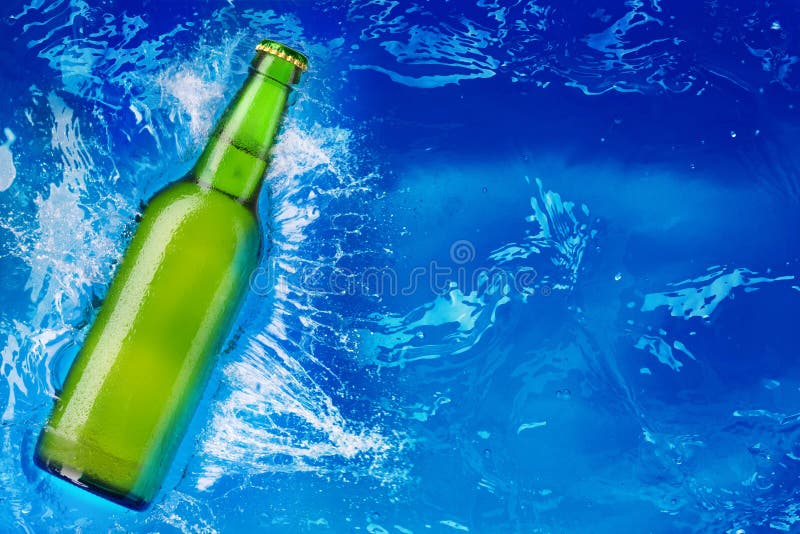 Green glass bottle in water