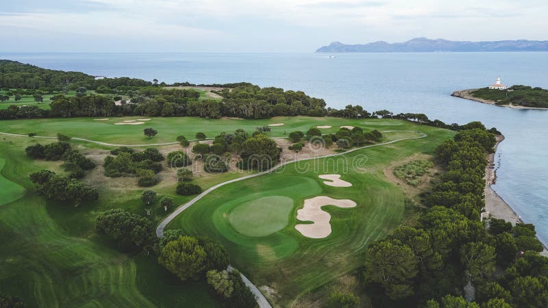 green golf course on hill near sea on cloudy day in Mallorca, Spain