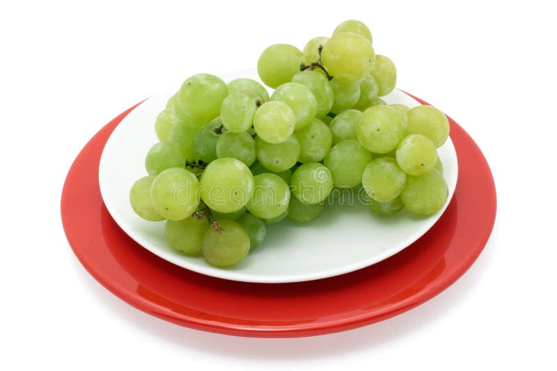 Green grapes on a plate isolated with path