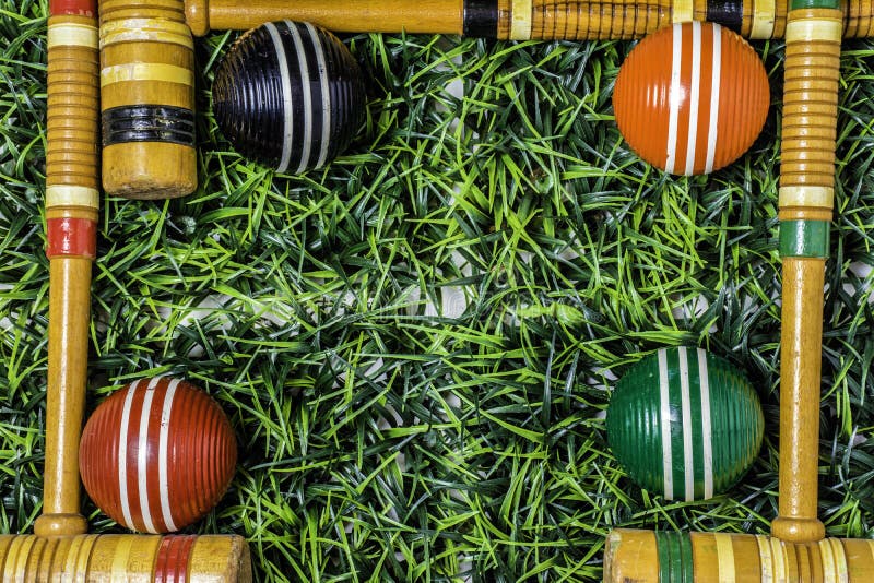 Frame of Croquet Mallets and Balls on Grass