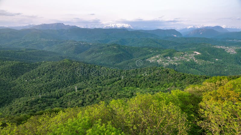 Clouds And Fog On The Slopes Of Mountain Ranges With Snowy Peaks In