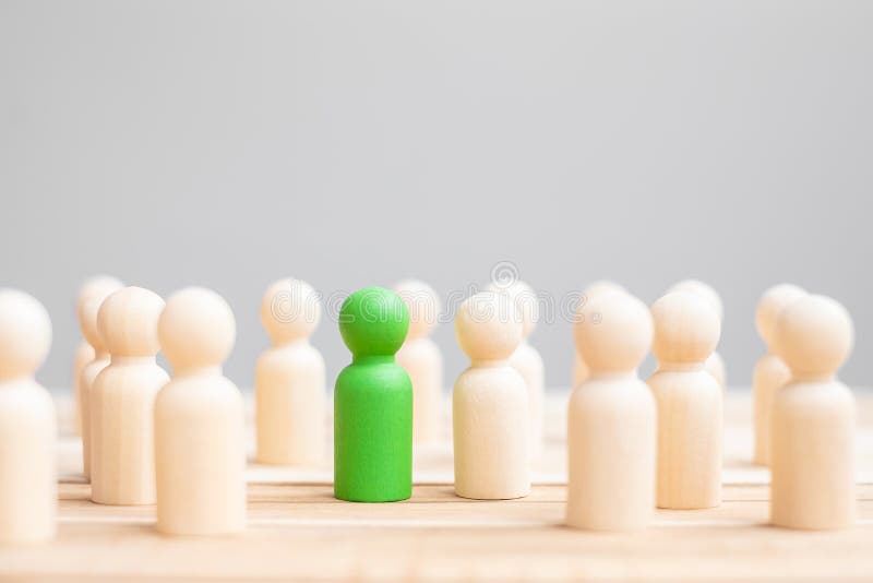 Green leader business man with crowd of wooden people. leadership, business, team, teamwork and Human resource management concept