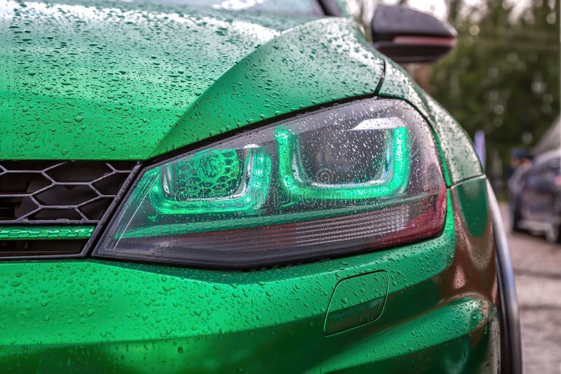 Green Led Headlights with Lens on Green Modified Tuned Car. Custom Car