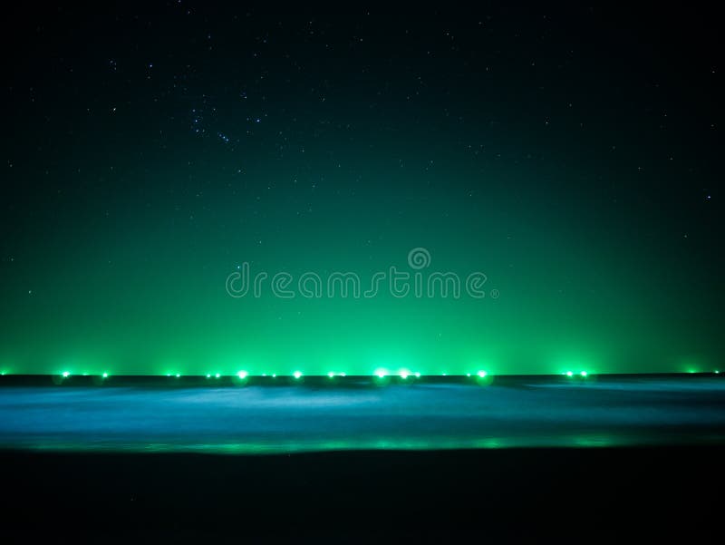 Green Light at Horizon Line Over the Sea, Light from Fishing Boat