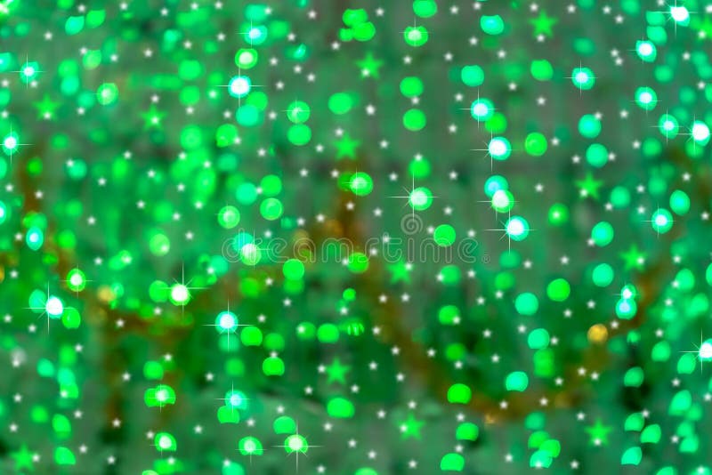 Defocused image of a Christmas tree green lights with bokeh, stars and sparkles for abstract background. Defocused image of a Christmas tree green lights with bokeh, stars and sparkles for abstract background.