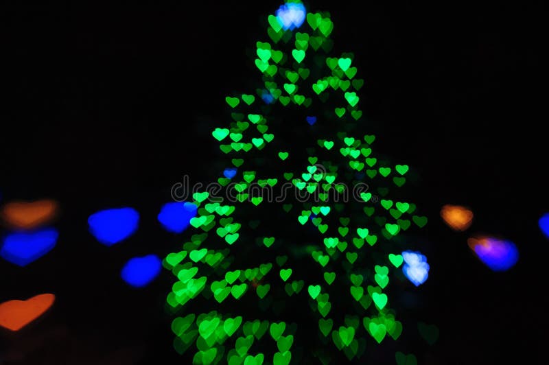 Green Lights on the Christmas Tree in the Form of Hearts Blurry Stock