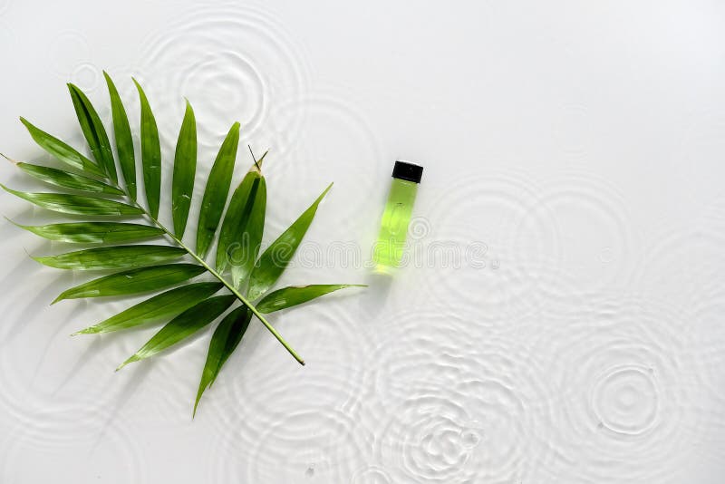 Green liquid product for beauty facial massage therapy, Self made skincare product. Flat lay, simple composition, palm