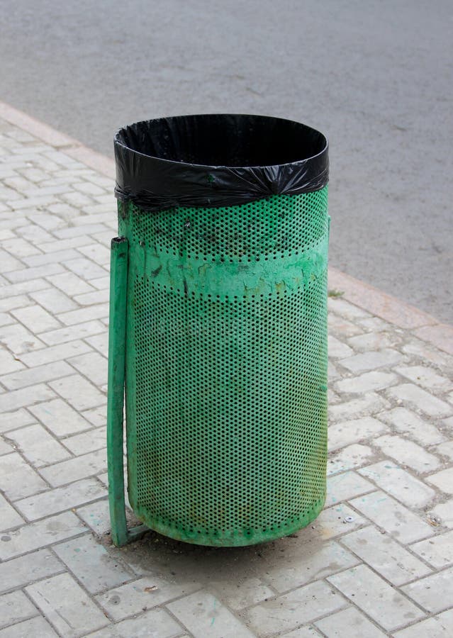 A Green Litter Bin with Plastic Bag in it on a Street Stock Image