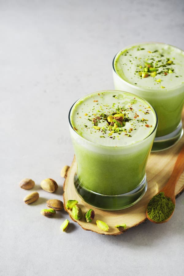 Green Matcha Latte with Pistachios and Matcha Powder Stock Photo