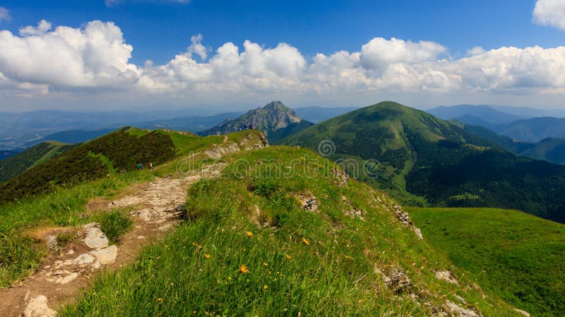 Green mountain ridge in nice weather, with blue sky and white clouds. Mala Fatra