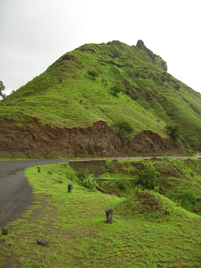 Green mountain and road