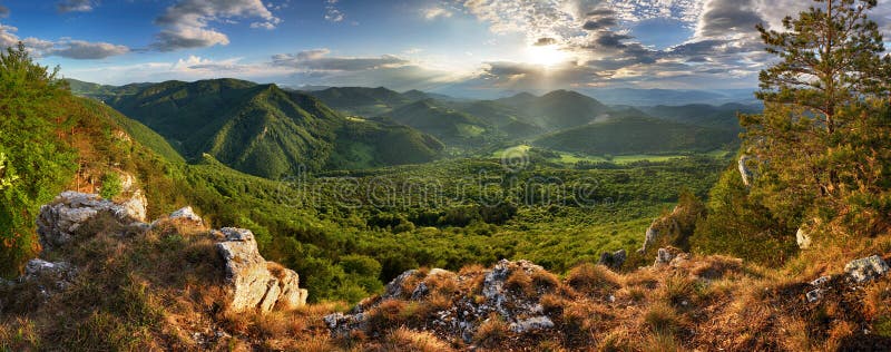 Green mountains landscape with sun