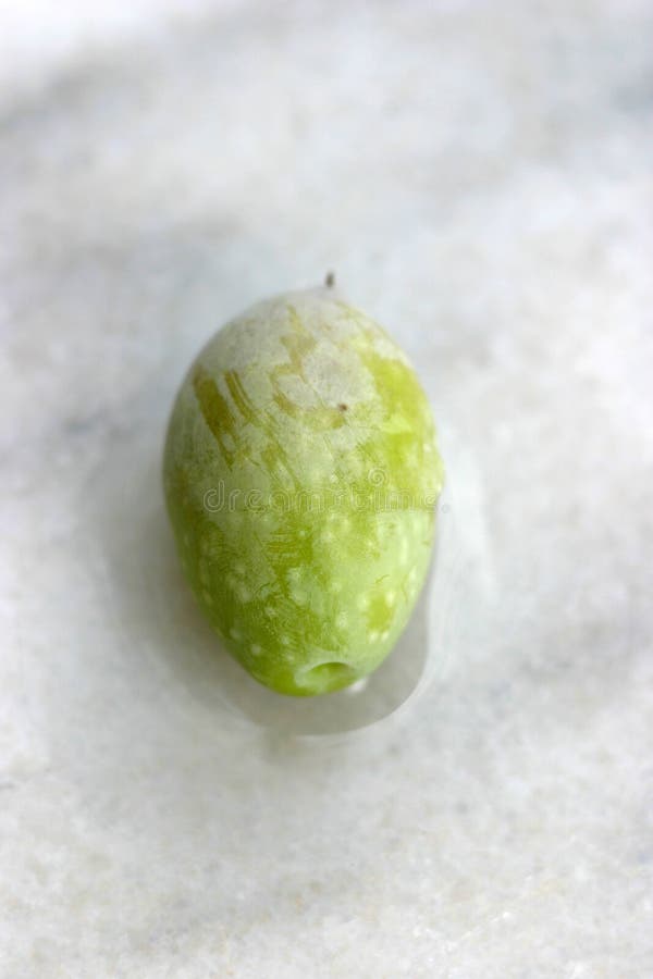 Green olive on marble