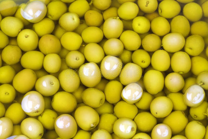 Green olive in olive oil stock photo. Image of extra 77397782