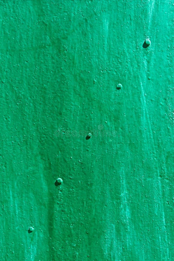 Green painted metal sheet with rivets diagonally