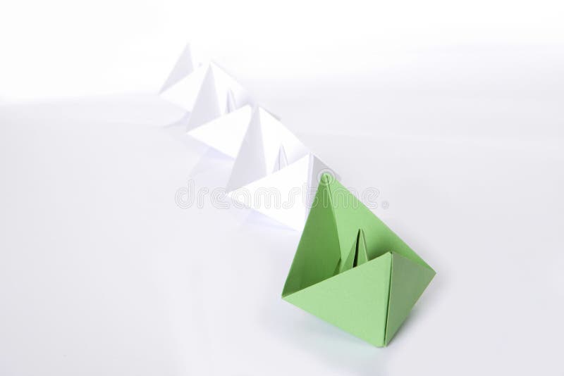 Green paper boat is leading