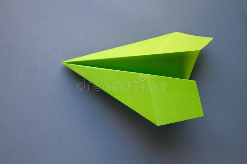 Green Paper Plane Origami Isolated on a Grey Background Stock Image