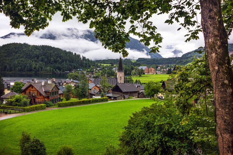 Green pastures of Alpine village Altaussee in a rainy morning