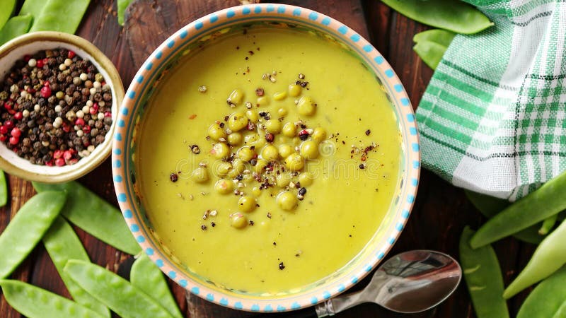 Green pea cream soup in grey bowl