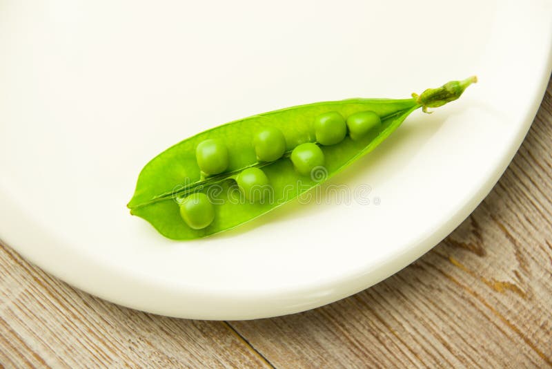 Green Pea Pod on the White Plate. Stock Photo Image of plate