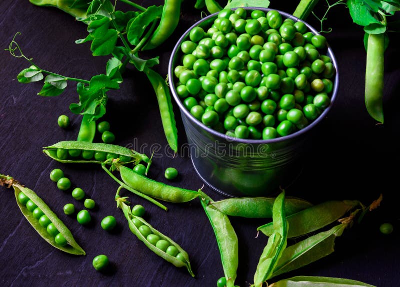 Green pea pods in a tin