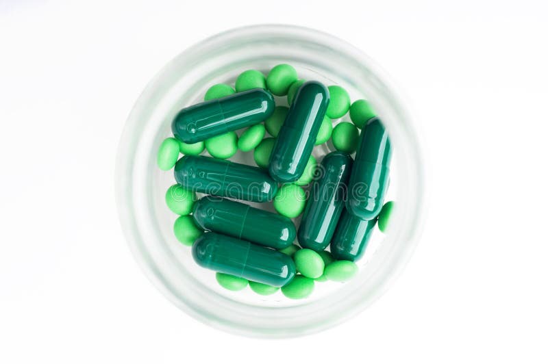 Green Pills And Capsules In A Bottle. Stock Image Image of assorted