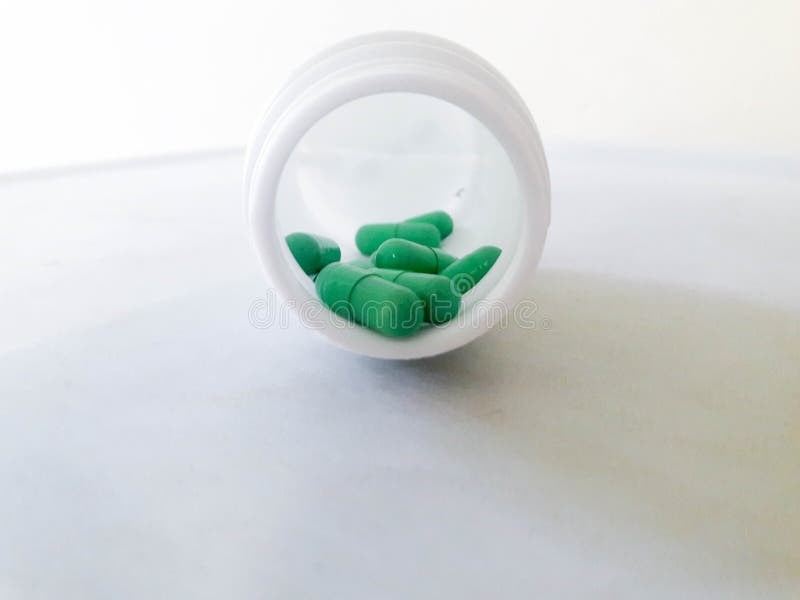 Green Pills and Pill Bottle Stock Photo Image of health, isolated