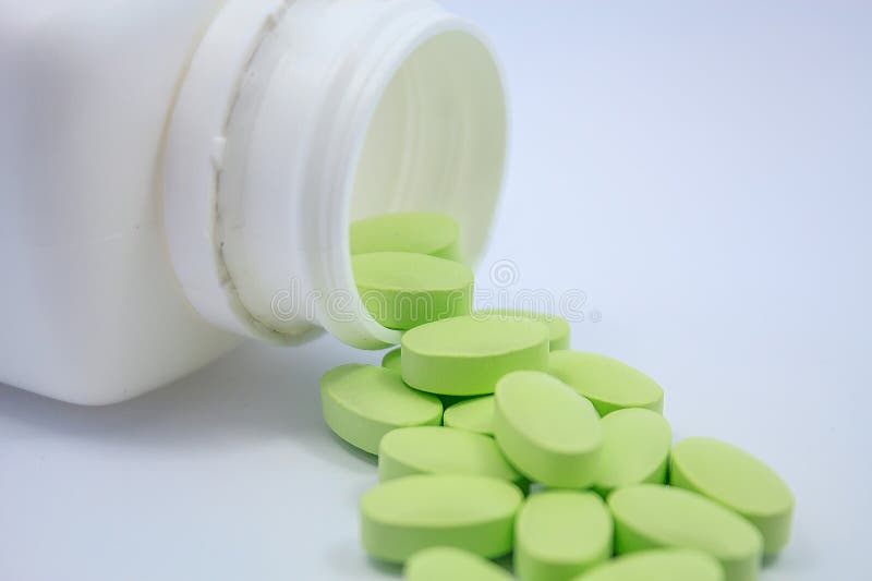 Green Pills and Pill Bottle on White Stock Image Image of closeup