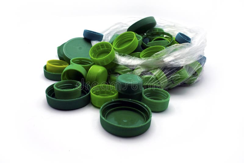Green plastic bottle caps sorted by colors in transparent single use plastic bags. PP an PET pollution