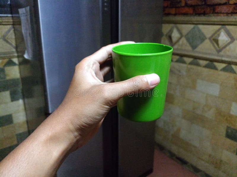 Plastic cup hold by hand stock image. Image of hold 152511079