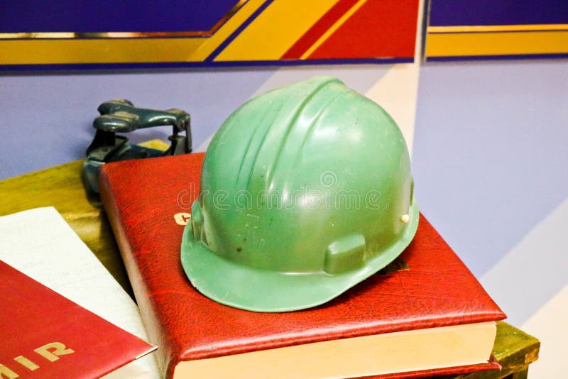 Green plastic safety helmet for the worker. Protective helmet to