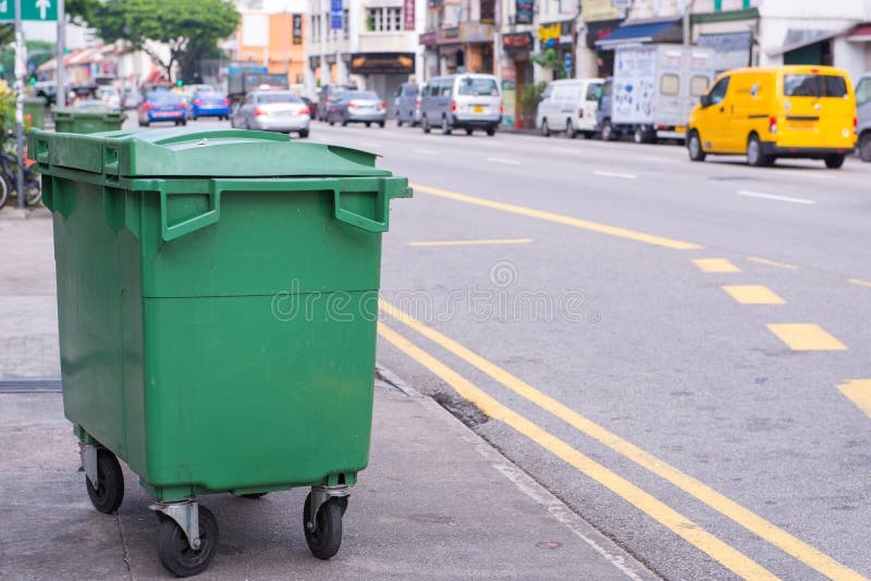 Green recycling bin container or garbage Trashcan on the street stock photography