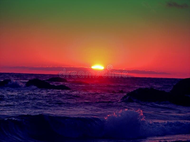 Green and red sunset over sea