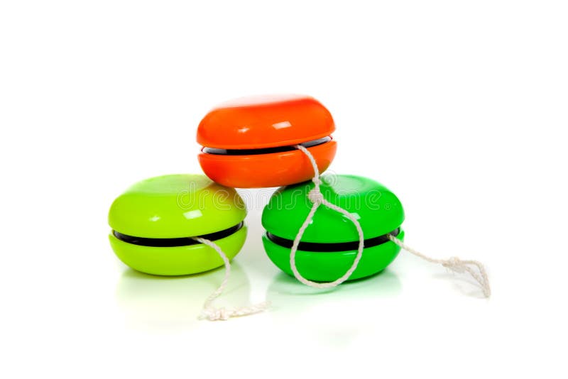 Green and red yoyos on a white background