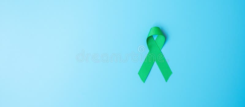 Green Ribbon On Color Background. Liver Cancer Concept Stock Photo