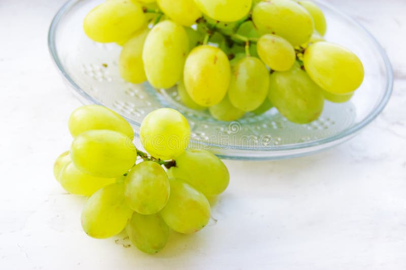 Green ripe grapes in plate