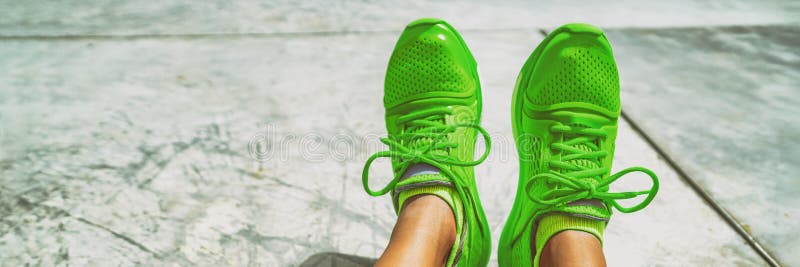 Green running shoes fashion footwear sportswear girl taking selfie of her trainers panoramic banner.