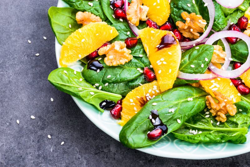 Green salad with fresh spinach leaves and orange.